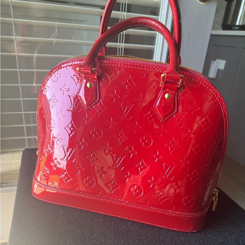 Louis Vuitton Alma red with LV all over gold hardware with two handles
